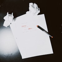 a piece of paper and a pen on a table
